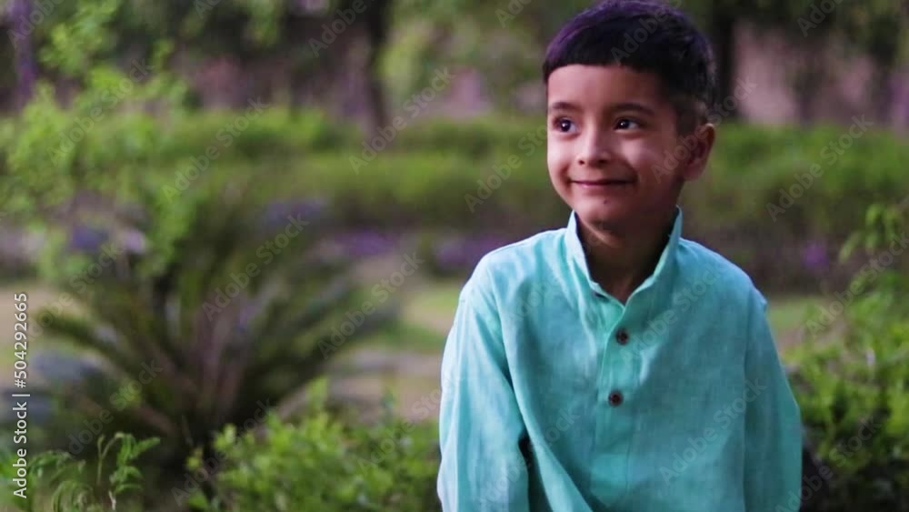 young kid different facial expression in traditional dress with green blurred background at evening young kid different facial expression in traditional dress with green blurred background at evening