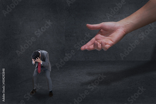 big hand give hope for painful business man in dark room