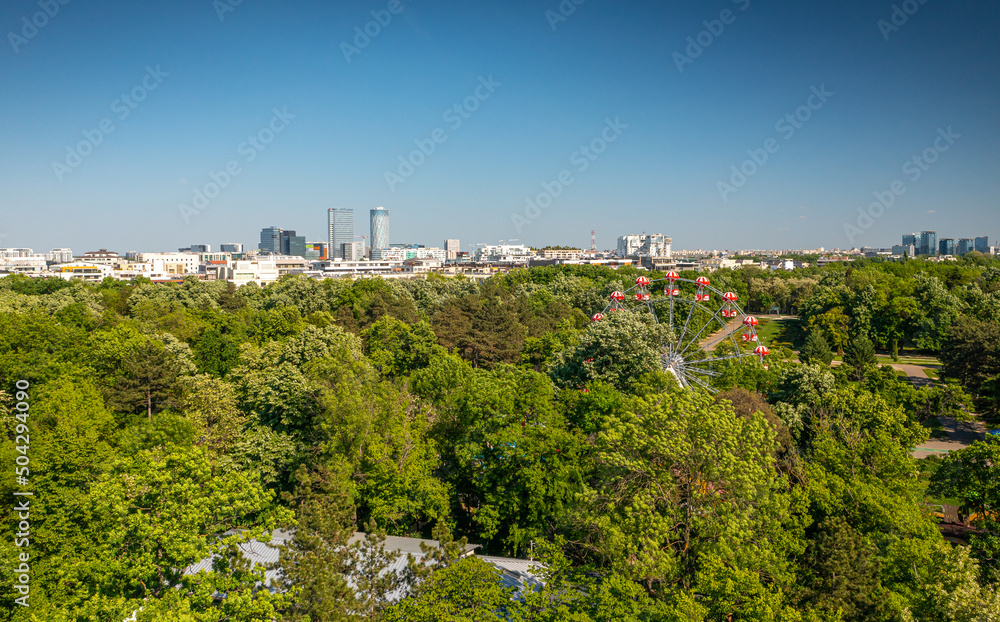 Bucharest from above, aerial view over Herastrau (King Michael I) Park, lake and the north part of the city with office building photographed during a summer sunny day.