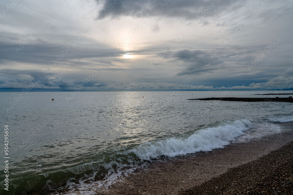 View of the Black Sea on the coast of Sochi against the sunset sky, Sochi, Krasnodar Krai, Russia