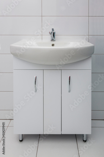 Floor stand with washbasin in bathroom with tile