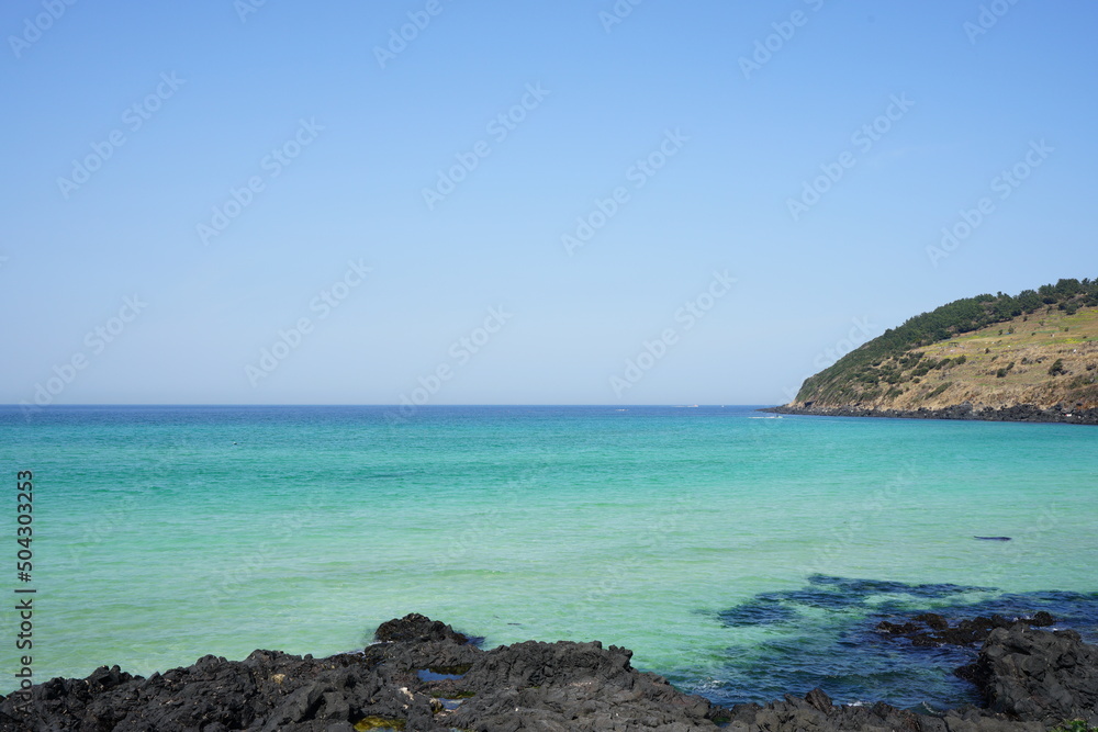 rock beach and clear bluish sea