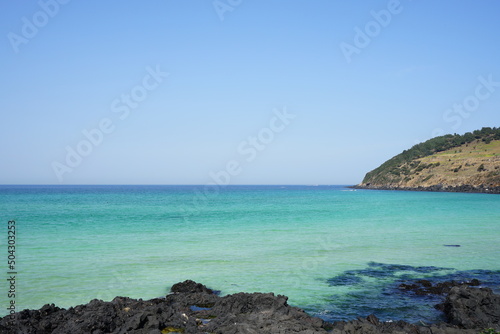 rock beach and clear bluish sea