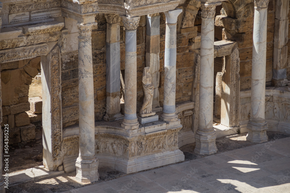 Turkey, Denizli, 29.08.2021: Ancient ruins of the Roman amphitheater in Hierapolis, Turkey. Statue and columns of the Colosseum. Ancient theater in Pamukkale. Travel in Turkey.