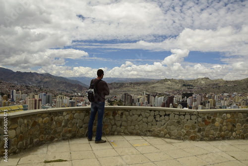 A man on the observation deck looks at the city landscape. La Paz, Bolivia