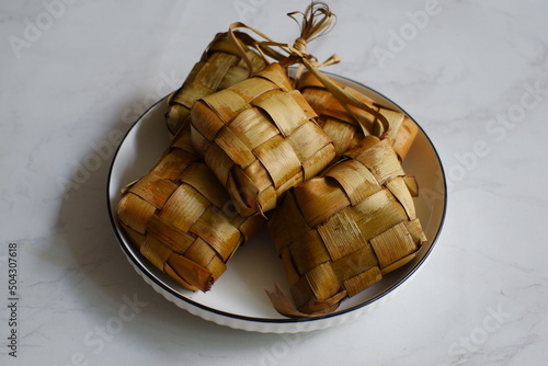 a bunch of ketupat or rice cake wrapped in coconut leaves 