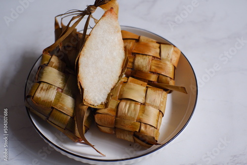 a bunch of ketupat or rice cake wrapped in coconut leaves  photo