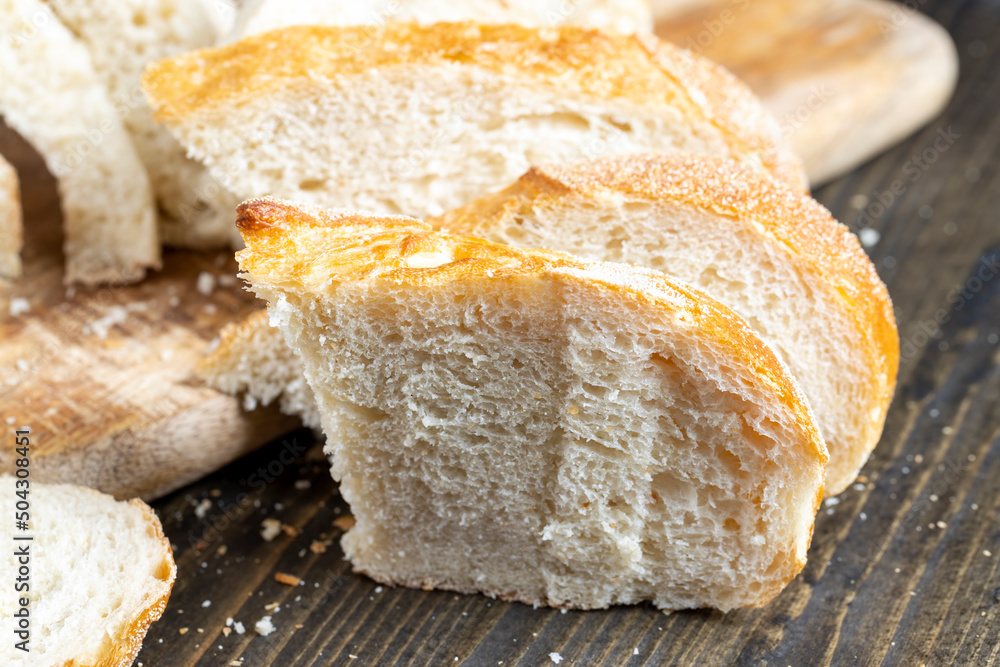 sliced loaf of bread on a cutting wooden board sliced loaf of bread on a cutting wooden board