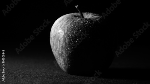 A scene of red apple on a black background at night