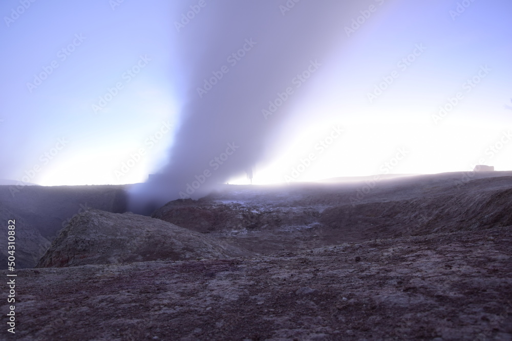 A geyser shoots out of the ground, a photo at dawn on a long exposure., on Eduardo Avaroa National Reserve in Uyuni