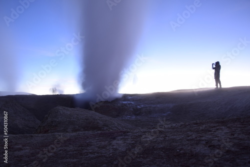 A geyser shoots out of the ground  a photo at dawn on a long exposure.  on Eduardo Avaroa National Reserve in Uyuni