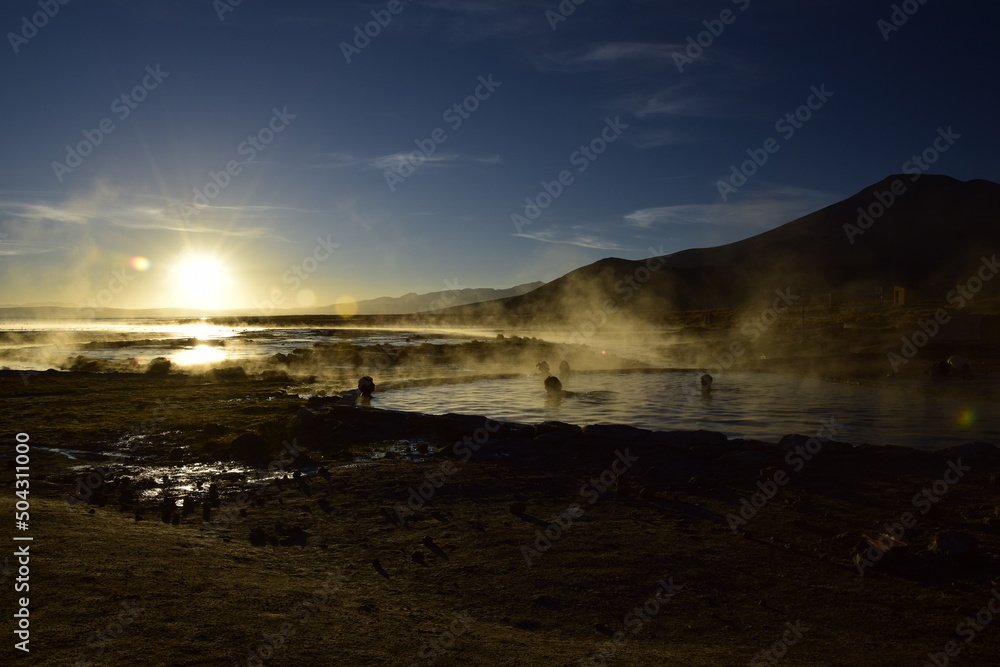 Uyuni, Bolivia - 10 february 2017: Tourists swim in a hot spring at sunrise in Eduardo Avaroa National Reserve in Uyuni