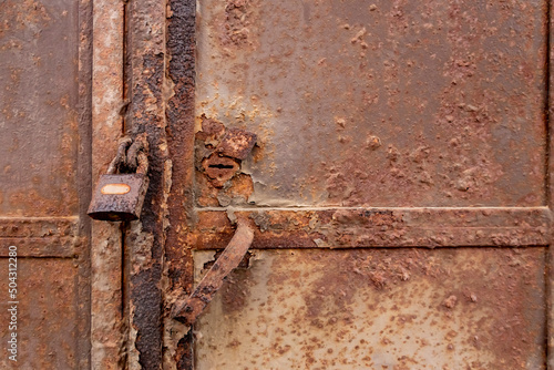 Rusty castle on a rusty iron gate