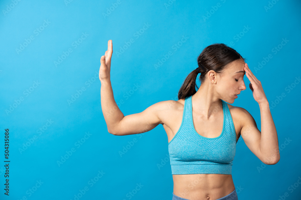 Hispanic sportswoman making stop sign at any temptation or problem with copy space isolated on blue background. Hispanic sportswoman making stop sign at any temptation or problem with copy space isolated on blue background.