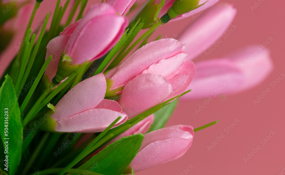 Artificial pink flowers on a pink background. Artificial pink flowers on a pink background.