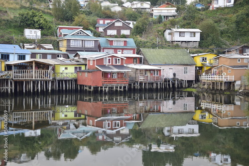 Houses on stilts (palafitos) reflected in the water in Castro, Chiloe Island, Patagonia, Chile