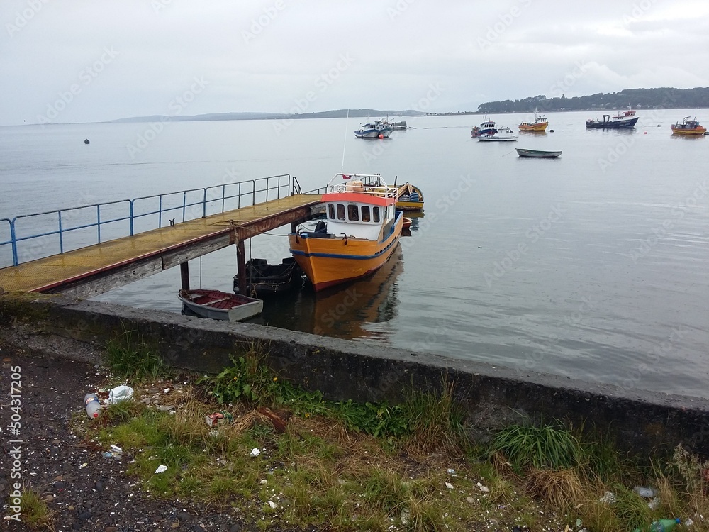 Fototapeta premium QUELLON, CHILE. Colourful fishing boats in the coastal town of Quellon on the island of Chiloe in Chile