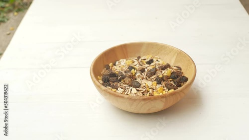 Woman hand placing a natural bowl with organic muesli