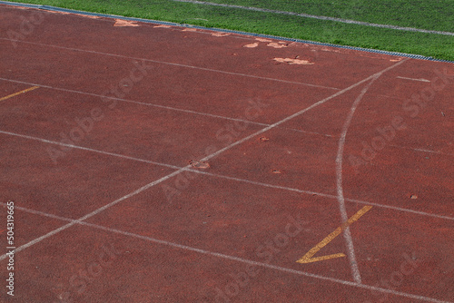 the red surface of the old running track at the stadium