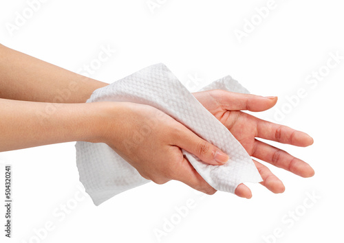 Woman wiping her hands with napkin on white background.