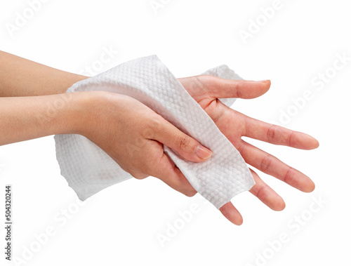 Woman wiping her hands with napkin on white background.