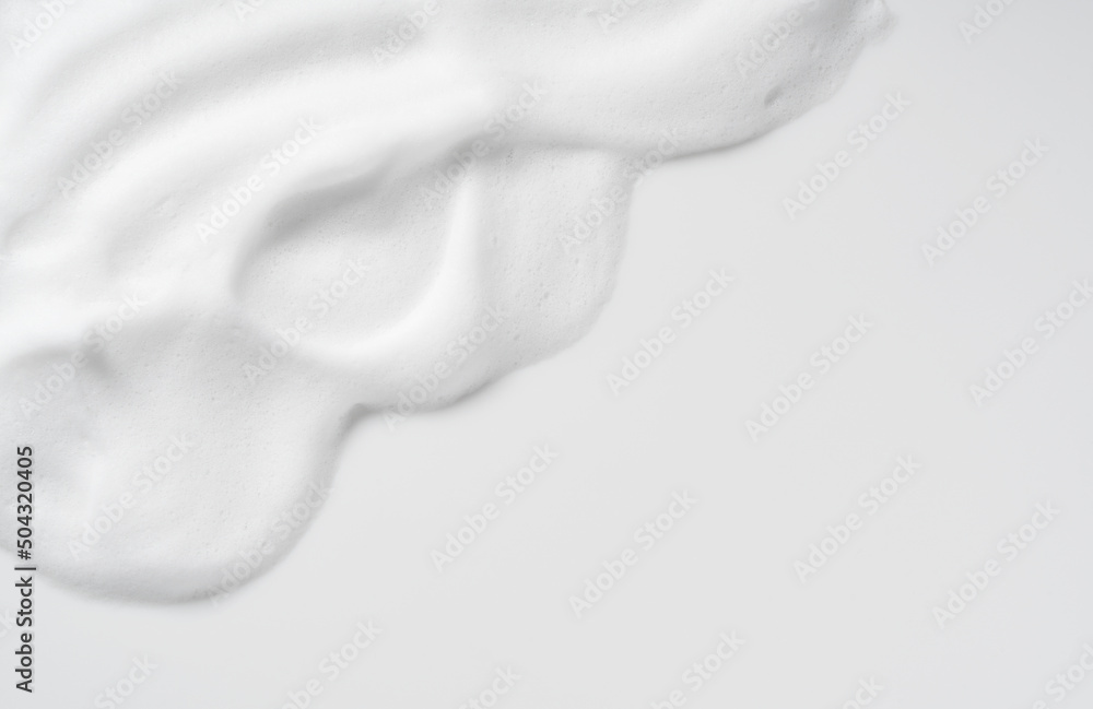 Skincare cleanser foam texture. Copy space and soap bubbles on white background. - obrazy, fototapety, plakaty 