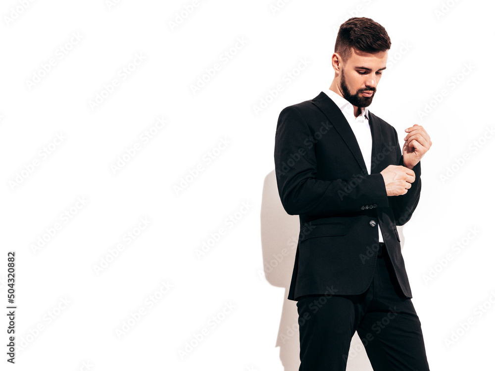 Portrait of handsome confident stylish hipster lambersexual model. Sexy modern man dressed in elegant black suit. Fashion male posing in studio near white wall. Isolated Portrait of handsome confident stylish hipster lambersexual model. Sexy modern man dressed in elegant black suit. Fashion male posing in studio near white wall. Isolated