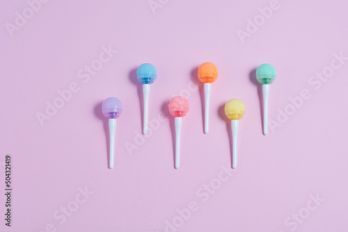 Close up of  colorfull lollipops on a pink backround. Minimalistic flat lay, top view, copy space. © Malena