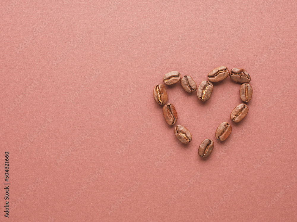 Heart shape of coffee beans on a brown background with space for your text or product Heart shape of coffee beans on a brown background with space for your text or product