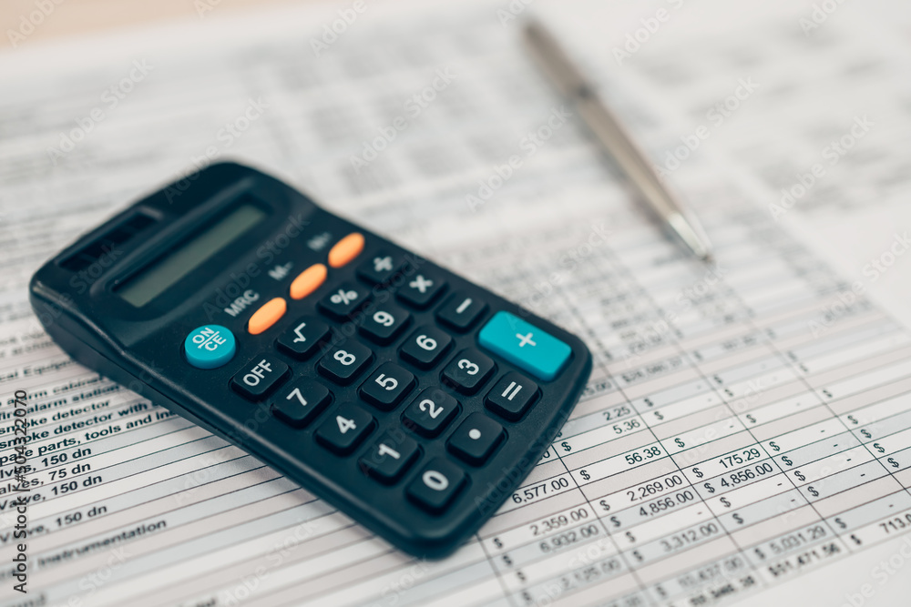 Pen and calculator on desk office. Object for calculator to calculate balance, projit, currency and cost. Accounting and Financial concept. Pen and calculator on desk office. Object for calculator to calculate balance, projit, currency and cost. Accounting and Financial concept.