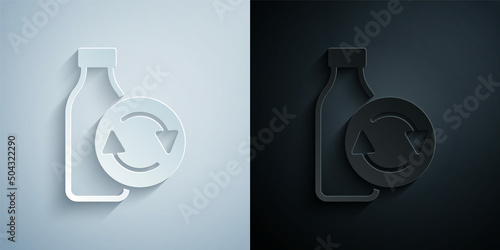 Paper cut Recycling plastic bottle icon isolated on grey and black background. Paper art style. Vector