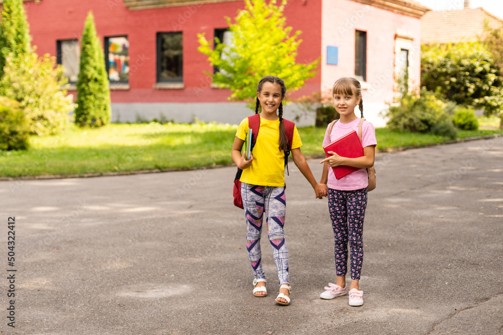 Foto de Lucky to meet each other. Cheerful smart schoolgirls. Happy