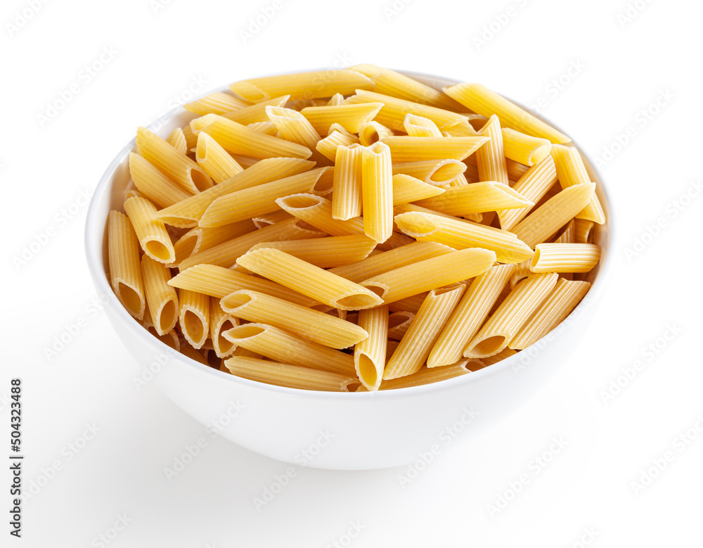 Uncooked penne pasta in white bowl isolated on white background with clipping path Uncooked penne pasta in white bowl isolated on white background with clipping path