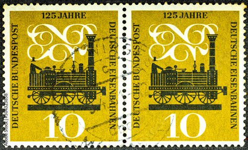 GERMANY - CIRCA 1960: A postage stamp printed in Germany showing Adler the first steam locomotive between N rnberg and F rth. 125 years of German railways. CIRCA 1960. photo