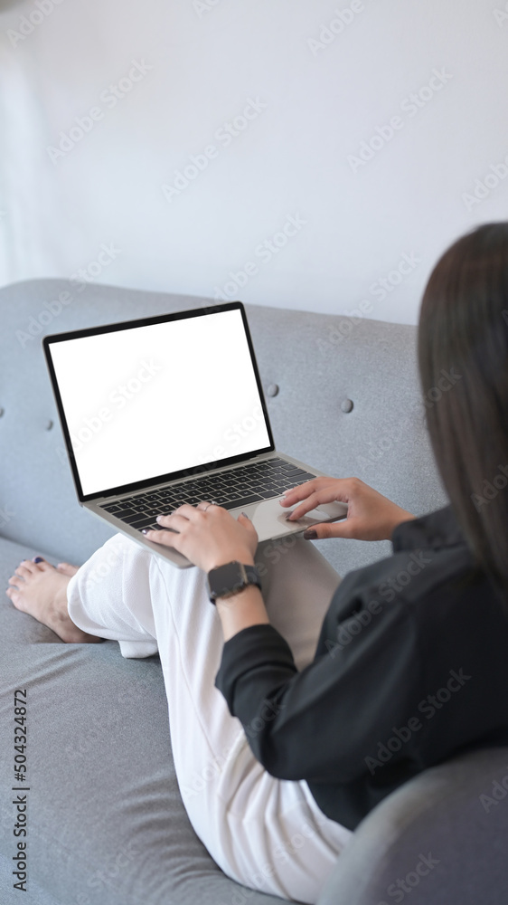 Casual woman resting on sofa and surfing internet with laptop computer. Casual woman resting on sofa and surfing internet with laptop computer.