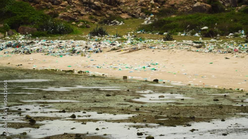Rubbish Scattered On The Beach Shore In Vietnam. - Pan Left Shot Rubbish Scattered On The Beach Shore In Vietnam. - Pan Left Shot