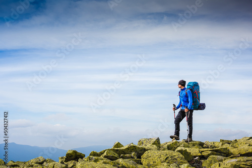 Happy hiker walking in the mountains. Freedom and happiness, achievement concept