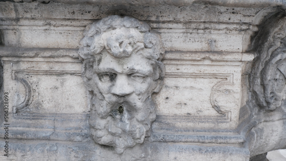 Ancient Roman fountain in the shape of a head