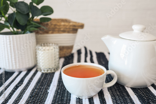 Fototapeta Naklejka Na Ścianę i Meble -  Cup of tea on the table, cozy interior photo in the kitchen