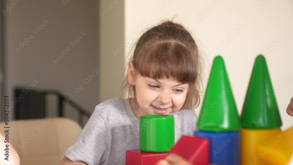 little girl and baby boy play in kindergarten. a group of children play toys cubes and cars on the table in kindergarten. happy family preschool education concept. nursery indoor baby toddler home little girl and baby boy play in kindergarten. a group of children play toys cubes and cars on the table in kindergarten. happy family preschool education concept. nursery indoor baby toddler home