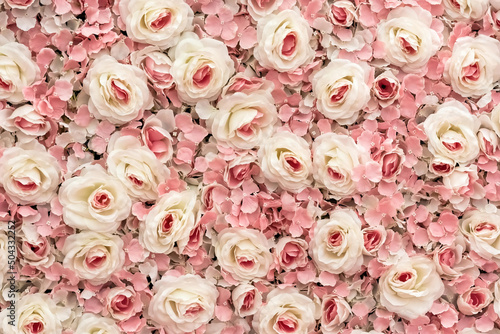 a wall of pink artificial roses