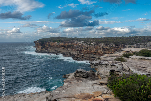 Landscape view of the coastal cliffs and sea between Maroubra Beach and Malabar Beach  Randwick  Sydney  Australia. Dramatic cloud formations on the blue sky.