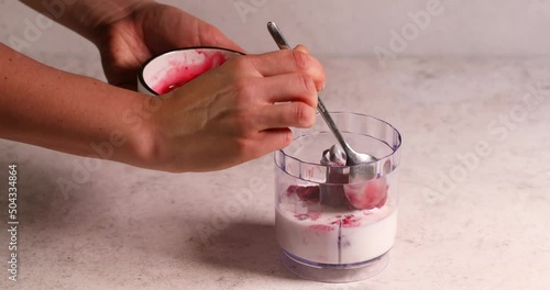 Adding raspberry in blender smoothy preparation