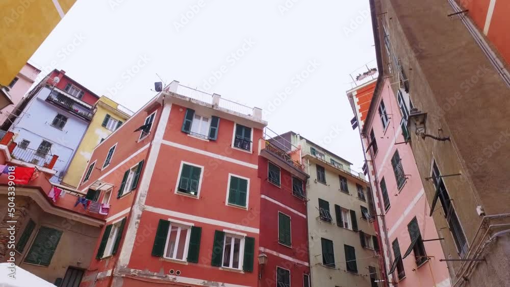 Walking through an ancient narrow street in Cinque Terre. Old town, architecture, color houses, narrow alleys in summer time. Walking through an ancient narrow street in Cinque Terre. Old town, architecture, color houses, narrow alleys in summer time.