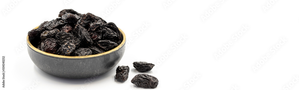 Black dried raisins on a white background. healthy and fresh.nuts. Close-up. Copy space. Space for text Black dried raisins on a white background. healthy and fresh.nuts. Close-up. Copy space. Space for text