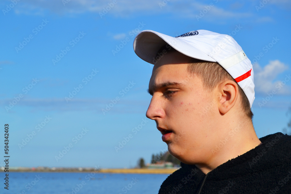 Portrait of a young autistic guy, relaxed looking at the sea, on vacation. Portrait of a young autistic guy, relaxed looking at the sea, on vacation.