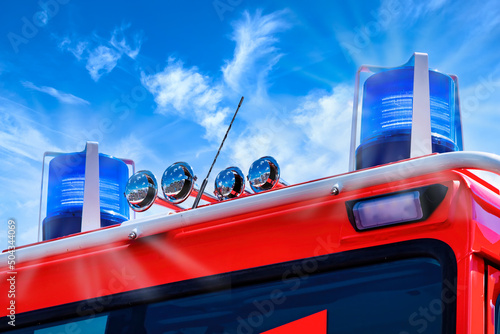 Close up of a firefighter truck with blue flash against blue sky. Nahansicht Feuerwehrauto mit Blaulicht photo