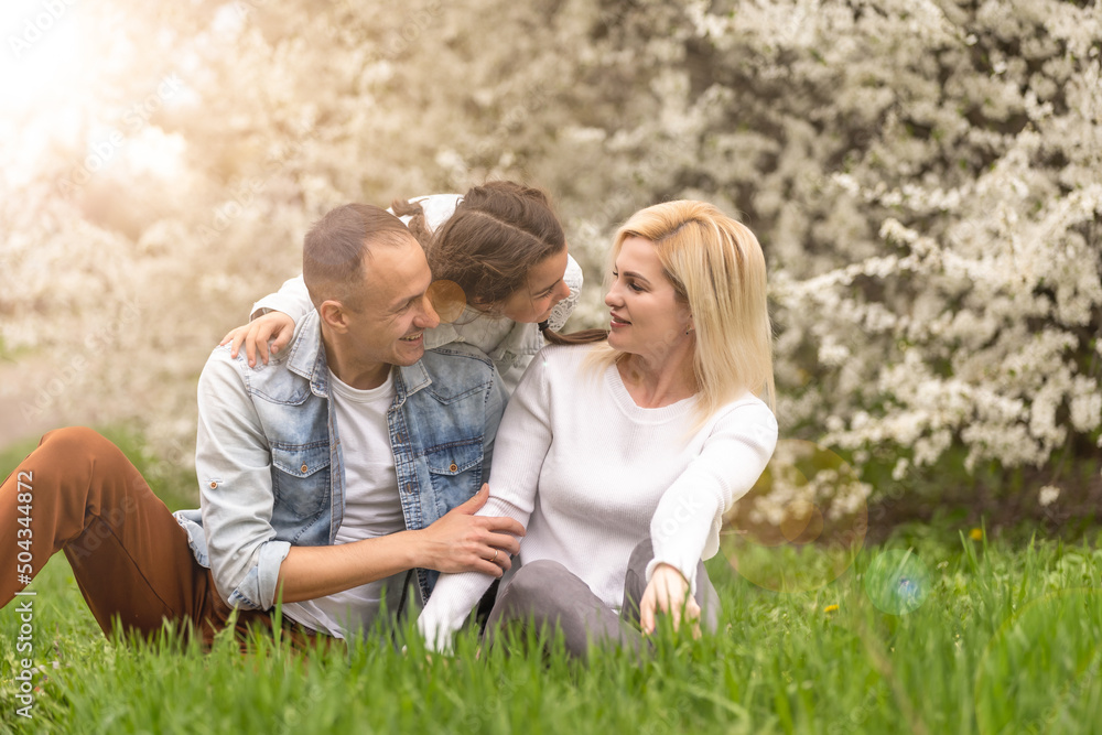 Happy male and female playing with child outside, spring. Happy male and female playing with child outside, spring.