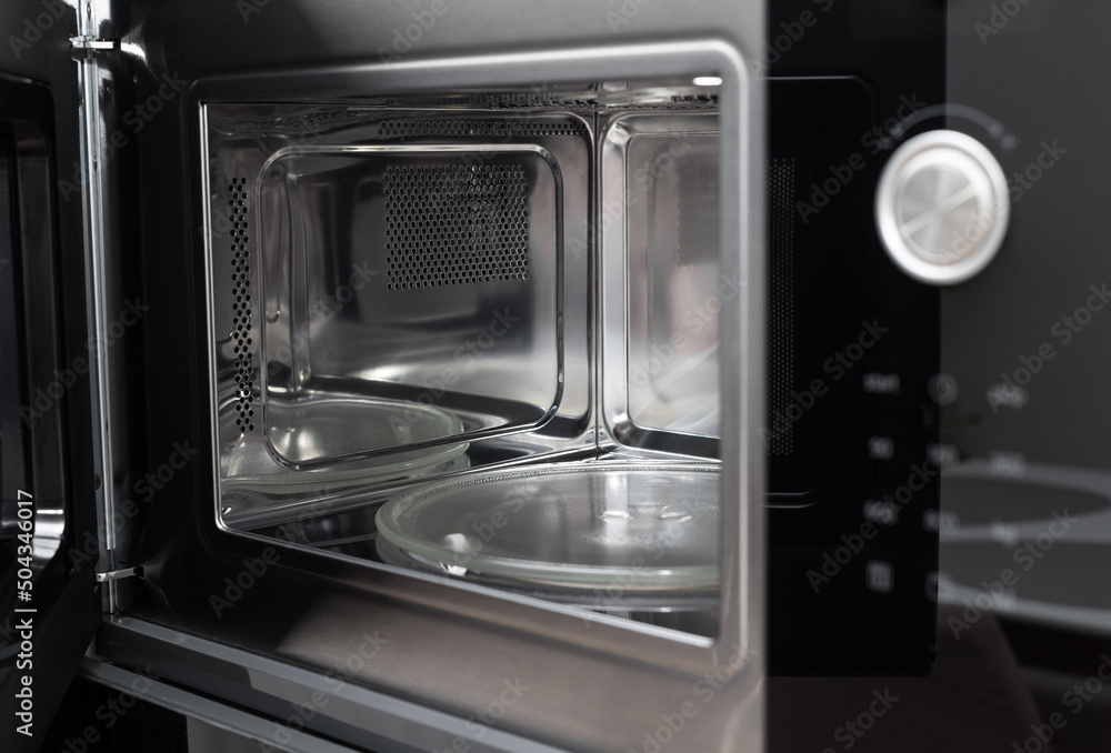 Inside view of clean, empty microwave built in kitchen cabinet. modern kitchen furniture. selective focus Inside view of clean, empty microwave built in kitchen cabinet. modern kitchen furniture. selective focus