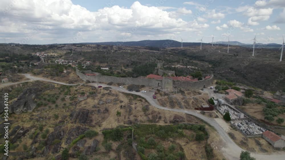 Aerial arc shows Sortelha Fortress, defensive wall and surrounding landscape Aerial arc shows Sortelha Fortress, defensive wall and surrounding landscape